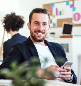demo-attachment-526-a-portrait-of-young-businessman-with-smartphone-A2GKEC4